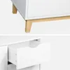 A close-up view of a white dresser with wooden legs and an open drawer. Anteprima dell’immagine prodotto