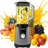 A blender filled with fruit is surrounded by various fruits and splashes of orange juice, suggesting a smoothie-making context. Produktbild-Vorschau