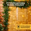 Christmas lights draped over wooden doors, with a brick wall on the left. Podgląd zdjęcia produktu