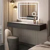 A modern vanity area with a lighted mirror, makeup, and a stool. Náhled obrázku produktu