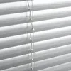 A close-up view of white horizontal blinds. Produktbild-Vorschau