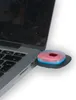 A close-up shot of a USB device attached to a laptop. Voir les images du produit