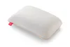 A white pillow with a textured pattern and an orange trim, with a red tag on the side. Produktbild-Vorschau