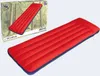 A red and blue inflatable mattress is shown next to its packaging, which features a forest scene. Produktbild-Vorschau