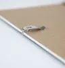 A close-up shot of a metal clip on the back of a picture frame. Produktbild-Vorschau