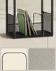 Close-up of a black metal record stand with records inside, highlighting the mesh material and rounded edges. Náhled obrázku produktu