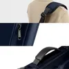 Close-up shots of a navy blue bag, showing a shoulder strap, a zipper, and a handle. Produktbild-Vorschau