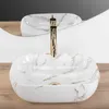 A close-up shot of a white marble-patterned countertop sink with a gold faucet, set on a wooden surface. Anteprima dell’immagine prodotto