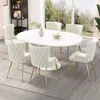 A dining room setting with an oval table and chairs.