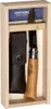 A wooden box containing an Opinel pocket knife, a leather sheath, and a small sharpening stone. Anteprima dell’immagine prodotto
