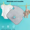 A baby onesie and a plush bunny toy are hanging on a clothesline, with a gray baby bib or pad in the center. Icons representing absorbency, machine washability, and reusability are at the bottom. Produktbild-Vorschau