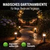 A garden path at night, illuminated by solar lamps, with seating area in the background. Anteprima dell’immagine prodotto
