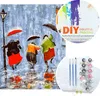 A collage showing a painting of people with umbrellas in the rain, and a DIY digital painting kit with paints and brushes. Produktbild-Vorschau