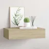 A wooden floating shelf mounted on a white wall, decorated with a framed picture of leaves, a potted cactus, and a reed diffuser. Produktbild-Vorschau