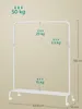 A white clothes rack with dimensions and weight capacity indicated by text and arrows. Produktbild-Vorschau