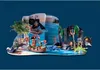 A pirate-themed Playmobil advent calendar playset with figures, a boat, a ship in the background, and underwater elements. Anteprima dell’immagine prodotto