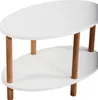A white oval coffee table with wooden legs, viewed from an angle. Voir les images du produit