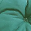 A close-up of a green tufted cushion. Produktbild-Vorschau