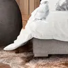 A close-up view of a bed with a duvet cover featuring a panda print. The bed is placed on a rug in a room with wooden elements. Produktbild-Vorschau