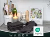 A kitchen counter with dish towels, a cookbook, and kitchen utensils. Produktbild-Vorschau
