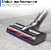 A close-up shot of a vacuum cleaner head with a brush roller, cleaning a carpet. Produktbild-Vorschau
