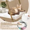 A cat is resting on a shelf of a cat tree, with a plant on another shelf. Inset images show a close-up of a mat and a washing machine with laundry. Produktbild-Vorschau