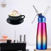 A whipped cream dispenser and a cup of coffee are displayed against a white background. Produktbild-Vorschau