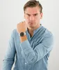 A man wearing a blue shirt and a watch. Produktbild-Vorschau