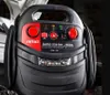 A close-up shot of a black and red car jump starter with various buttons and indicators. Podgląd zdjęcia produktu