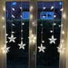 Star-shaped LED string lights hanging in a window at dusk. Produktbild-Vorschau