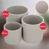 Three cylindrical planters of varying sizes are displayed against a neutral background. Red circles with white text indicating dimensions are overlaid on the image. Náhled obrázku produktu