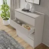 A modern white dresser with one drawer open, displaying decorative items, in a well-lit room with a plant and rug. Produktbild-Vorschau