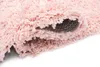 A close-up view of a pink rug, showing its texture and the underside. Produktbild-Vorschau