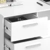 Close-up view of a white desk with drawers, showing a book inside one of the drawers. Produktbild-Vorschau