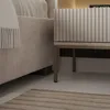 A close-up view of a bedside table next to a bed. Produktbild-Vorschau
