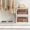A closet or storage area with clothing hanging on a rack and storage boxes. Náhľad obrázku produktu