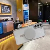 A phone case with a magnetic charging accessory attached is shown in a cafe setting. Anteprima dell’immagine prodotto