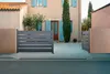 A modern house with a driveway and two gates in front of it. Produktbild-Vorschau
