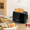 A black toaster with two slices of toast is shown on a wooden table, with some toast with toppings in the foreground. Produktbild-Vorschau