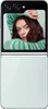 A woman is shown on the screen of a Samsung Galaxy Z Flip5 phone, which is closed. Podgląd zdjęcia produktu