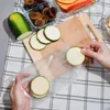 A person is preparing food by placing sliced zucchini into a vacuum seal bag. Náhľad obrázku produktu