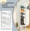 A white multi-tiered shoe rack with various shoes and boots displayed on its shelves, next to a wooden coat rack with a bag hanging from it. A potted plant is also visible. Produktbild-Vorschau