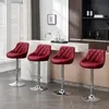 Four red bar stools are arranged in a modern kitchen setting. Produktbild-Vorschau