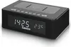 A black Lenco CR-580BK stereo FM-radiowecker with a digital display showing the time and temperature, and a wireless QI charging pad on top. Produktbild-Vorschau