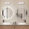 Two illuminated round mirrors are displayed above sinks in a bathroom setting, one labeled 'AUF' (on) and the other 'AUS' (off). Anteprima dell’immagine prodotto