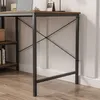 Close-up view of the leg and lower part of a desk with a shelf unit to the left. Podgląd zdjęcia produktu