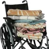 A stack of blankets folded and placed in a wheelchair. Produktbild-Vorschau