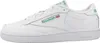 A side view of a single white Reebok Club 85 sneaker with green accents. Voir les images du produit