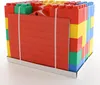 A set of large building blocks, resembling a house, is neatly packaged and strapped together on a white base. Produktbild-Vorschau
