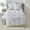A bed with bedding featuring a seagull pattern and stripes. Produktbild-Vorschau